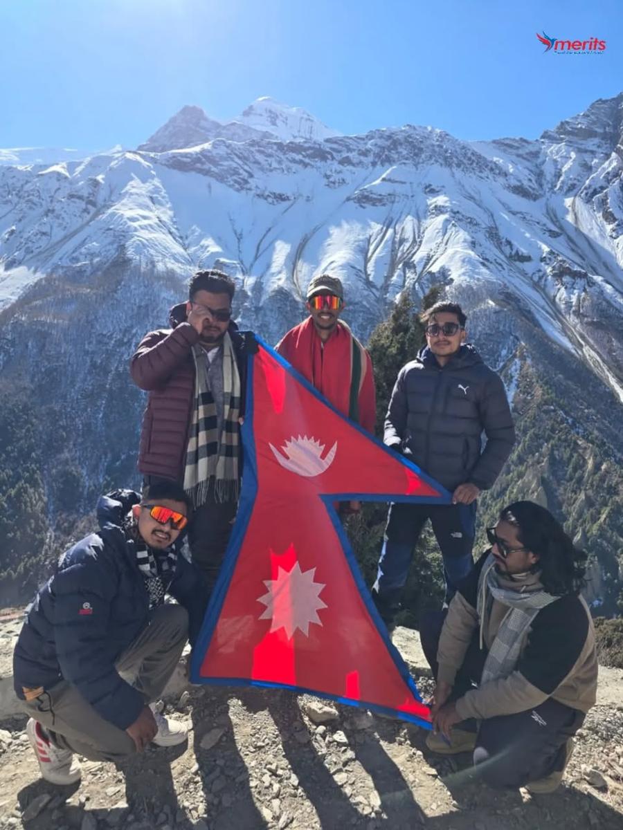Merits Travel clients with the Nepal flag on a trek
